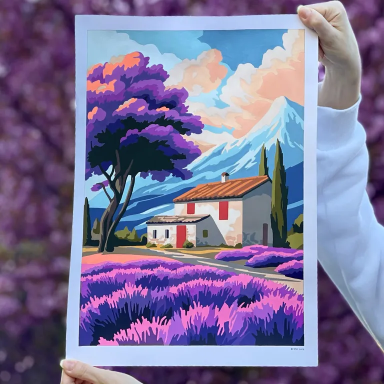 Hand holding a colored lavender field coloring page in front of blooming purple flowers