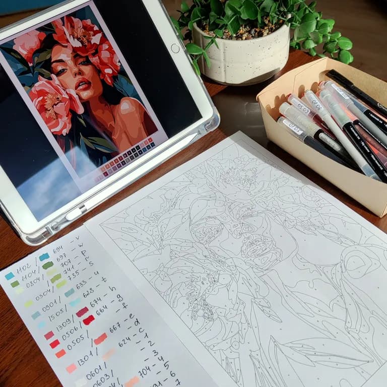 Printed coloring page with a handwritten color palette next to an iPad showing the finished artwork