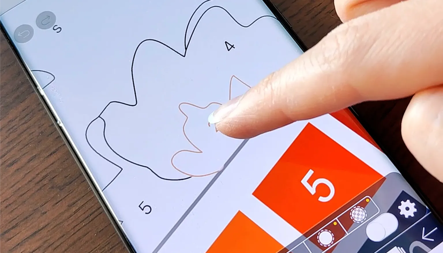 Coloring a paint-by-number page on a phone with a finger